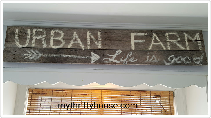 Creating a modern farmhouse kitchen using weathered wood and signs