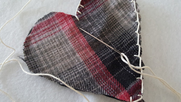 Just a simple whip stitch to sew the plaid flannel puffy heart Valentines.