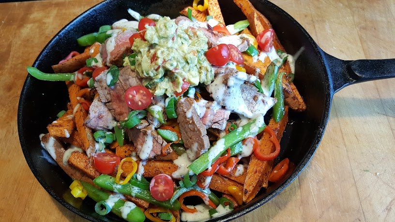 Whole30 Loaded Sweet Potato Fries served in a cast iron skillet.