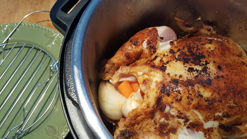 Making Whole30 Roasted Chicken and Broth with vegetable inserted into the cavity of the chicken. Browning the chicken before pressure cooking gives it that golden color.