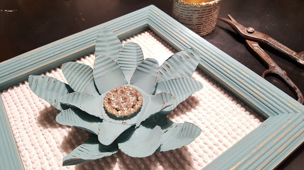 3 tin cans made into a painted metal flower