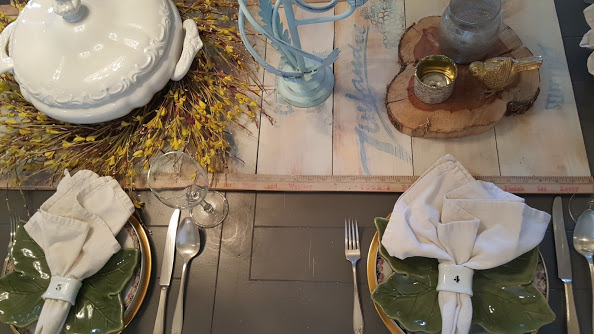 Elegant and simple table setting with wooden farmhouse table runner and forsythia wreath