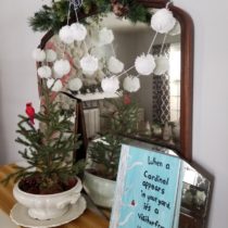pom pom garland with cardinals and vintage mirror