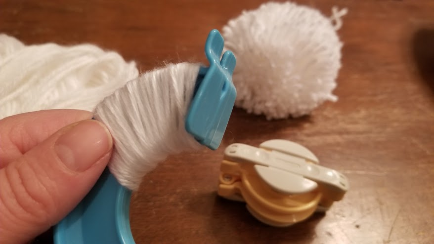 wrapping yarn to make pom pom garland