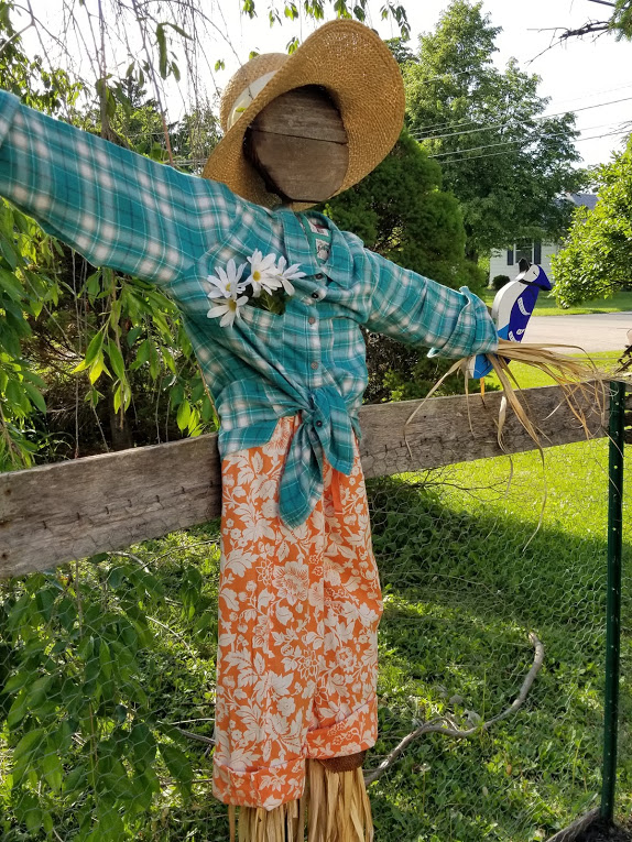 Cute garden scarecrow recycled from ugly scarecrow